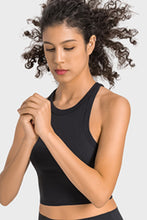 Woman in black Aero Racerback Tank performing yoga stretch