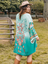 Model posing on ranch in Miravellea turquoise floral kimono cover-up