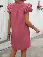 Model with her back turned showcasing the Dusty Pink Calivémuse™ Ruffled Notched Cap Sleeve Dress.