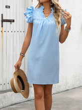 Model posing with a straw hat wearing the Pastel Blue Calivémuse™ cap sleeve dress in Tokyo.
