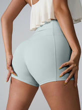 Momentum FlexTone Pocket Shorts back view in light blue with mid-back pocket.