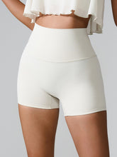 Momentum FlexTone Pocket Shorts front view in white high-waist design.
