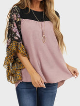 Side profile of model in BlossomEase Blouse, showcasing ruffle detail and floral sleeve pattern in moonlit mauve.