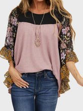 Woman wearing BlossomEase Blouse in moonlit mauve with floral sleeves and relaxed fit.
