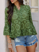 Model wearing Luméa™ Blouse in Moss, paired with distressed jeans and sandals at a summer brunch.