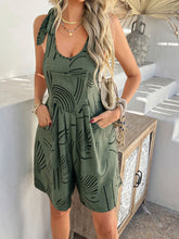 Moss green Kélure overalls layered over a bandeau and paired with high-top sneakers for a laid-back vibe.
