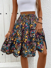 Model posing in multi turquoise Florévyn Floral Print Midi Skirt featuring frill tiers and ruffled hem