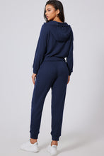 back view of navy Navaro Duo hoodie and joggers on person