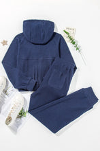 flat lay back view of navy Navaro Duo set styled with white sneakers