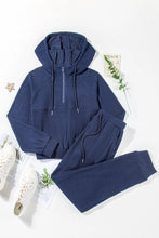 flat lay front view of navy Navaro Duo set paired with white sneakers
