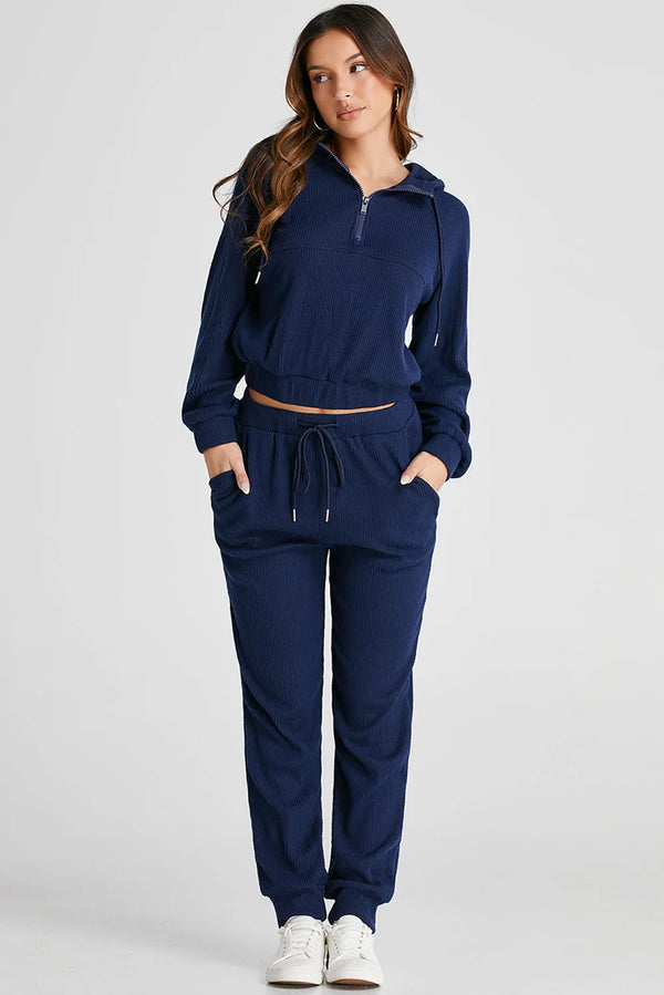 full body styled navy Navaro Duo set with white sneakers hands in pockets