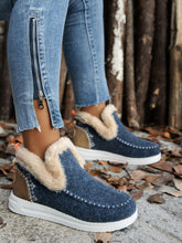 Person wearing the navy Furry Suede Round Toe Flat Sneakers, side angle