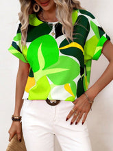 Model wearing a Neon Green contrast round neck short sleeve blouse, paired with light-wash jeans and subtle jewelry for a fresh, casual daytime look.