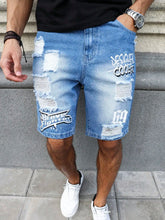 Model wearing men's blue ripped text logo printed denim shorts front pose.