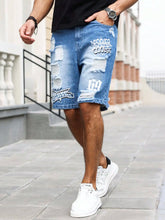 Walking side angle of men's blue ripped text logo printed denim shorts.