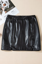 Close-up front flat lay of Nyvessia black PU leather mini skirt showcasing exposed seams and front mini slits