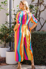 Back view of model wearing ODDI striped puff sleeve wide-leg jumpsuit showing flowy fit and back detail.