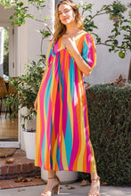Model wearing ODDI striped puff sleeve wide-leg jumpsuit in fuchsia-yellow front view.