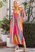 Model wearing ODDI striped jumpsuit at a garden brunch event styled with wedges and sunglasses.