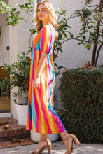 Side profile of model in ODDI striped puff sleeve wide-leg jumpsuit highlighting puff sleeve and wide-leg cut.