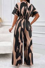 Close-up of the back neck button detail and wide-leg flow in Taupe.