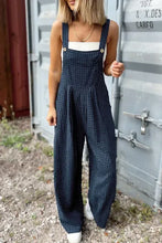 Model styled in plaid overalls for a casual outdoor brunch with sunglasses and a woven tote