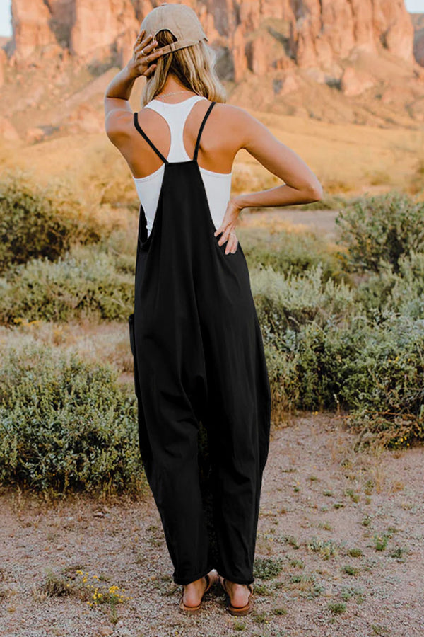 Model showing back view of Onvaira V-neck sleeveless jumpsuit in black.