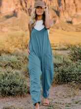 Model wearing Onvaira V-neck sleeveless jumpsuit front view in Azure.