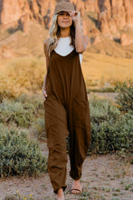 Model wearing Onvaira V-neck sleeveless jumpsuit front view in Brown.