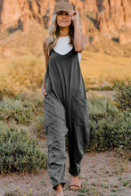 Model wearing Onvaira V-neck sleeveless jumpsuit front view in Gray.