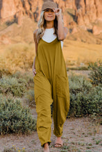 Model wearing Onvaira V-neck sleeveless jumpsuit front view in mustard.