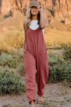 Model wearing Onvaira V-neck sleeveless jumpsuit front view in pink.