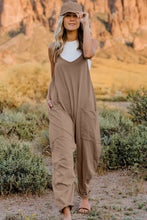 Model wearing Onvaira V-neck sleeveless jumpsuit front view in tan.
