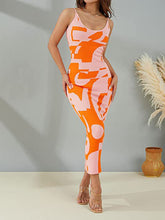 Front view of a model wearing the Orange Luxnometry Maxi Sweater Dress standing in a grand mansion hallway styled with tan heels.