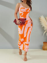 Woman taking a stroll in Orange Luxnometry Maxi Sweater Dress styled with a burgundy clutch and clear heels in a sunny garden path.
