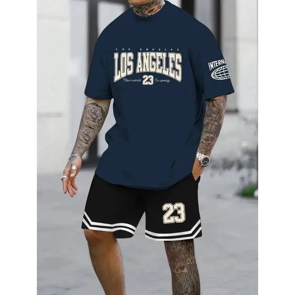 A man wearing a oversized navy blue Orrik 3D Printed Motion Set with 'Los Angeles 23' text and black shorts with the number '23' on them.