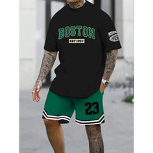Masculine wearing a oversized green Orrik 3D Printed Motion Set with 'Boston EST 1997' text on black round neck tee and green shorts with the number '23' on them.