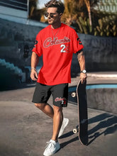 Man wearing a red Orrik 3D Printed Motion Set with 'Columbia 23' text on red round neck tee and black shorts with 'Columbia 23' on them. 