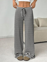 Relaxed lifestyle shot featuring Black Orvella LumaTide Striped Wide Leg Pants styled for everyday casual wear.
