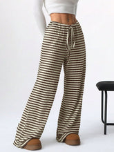 Relaxed lifestyle shot featuring Taupe Orvella LumaTide Striped Wide Leg Pants styled for casual chic looks.