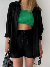 Model styled in black Own Your Lane Luxe Set, front view.