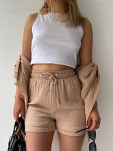 Close-up of camel textured fabric and waistband tie.