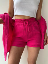 Close-up of deep rose textured fabric and waistband tie.