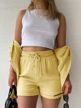 Model styled in true yellow Own Your Lane Luxe Set with flat sandals for poolside hangs and outdoor brunch.