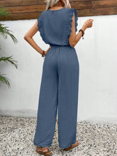 Back view of the Dusty Blue Papiloniya™ wide-leg pants, showcasing the elastic waistband, side pockets, round neck back button closure, and delicate lace ruffled cap sleeve trim detailing.