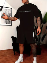 Person wearing a Obsidian Parivor FutureFlex Shorts Set with white text in a room with a plant and framed picture.