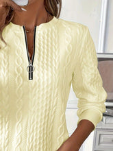 a close-up photo of the pastel yellow Sunset Coastal Bliss Texture Half Zip Long Sleeve Sweatshirt showcasing the zipper detailing