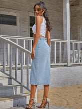Pastel blue Denivéra Button Skirt back view near balcony