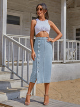 Pastel blue  Denivéra Button Skirt styled with knotted tank, sunglasses, hoops, and peep-toe heels