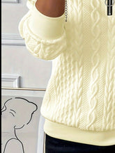 a close-up photo of the pastel yellow Sunset Coastal Bliss Texture Half Zip Long Sleeve Sweatshirt showcasing the sleeve and wavy texture detailing